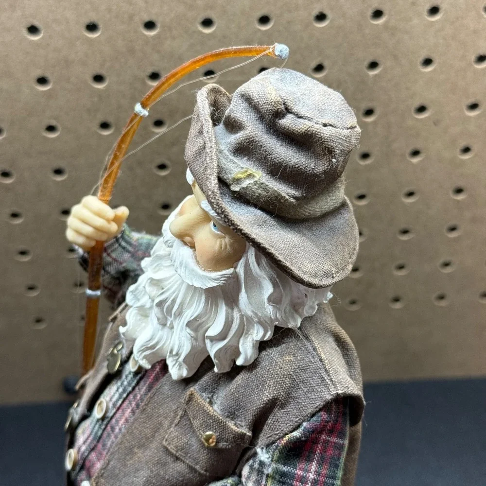Christmas 2005 Santa fishing figurine holding a fishing pole and fish plastic